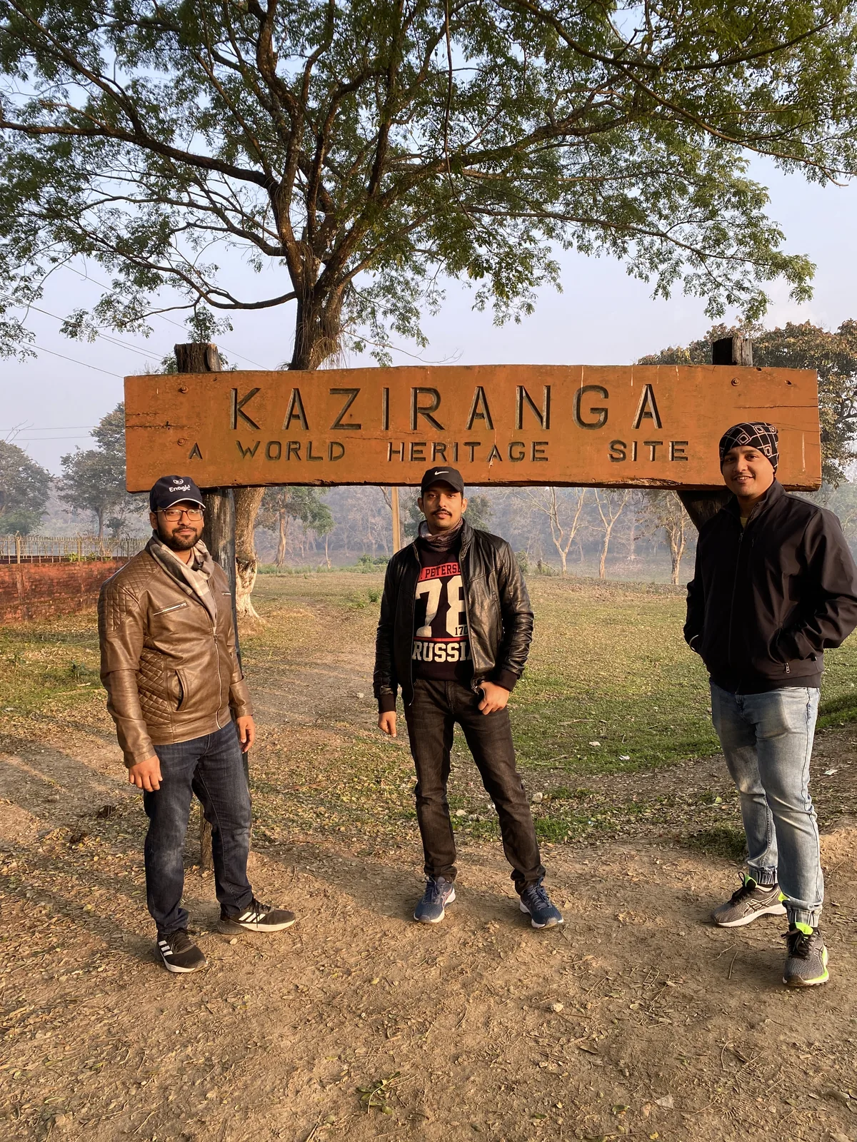 Visitors at the Kaziranga National Park entrance sign — A World Heritage Site
